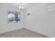 Bright, minimalist room with neutral tile and windows at 16784 W Hope Dr, Surprise, AZ 85388