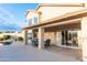 Covered patio with seating, overlooking the pool and mountains in the distance at 19276 N 90Th Pl, Scottsdale, AZ 85255