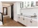Wet bar includes granite counters, white cabinetry, wine storage, and modern fixtures at 19276 N 90Th Pl, Scottsdale, AZ 85255