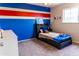 Stylish bedroom with bright blue, white, and red decor and a plush bed with ambient lighting at 19276 N 90Th Pl, Scottsdale, AZ 85255