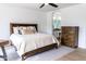 Sunlit bedroom featuring a cozy bed, stylish furnishings, and a view into an en-suite bathroom at 19276 N 90Th Pl, Scottsdale, AZ 85255