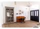 Bright entryway featuring tile floors, high ceilings, piano, and a decorative cabinet at 19276 N 90Th Pl, Scottsdale, AZ 85255