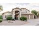 Inviting two-story home featuring a well-manicured yard and a welcoming arched entryway at 19276 N 90Th Pl, Scottsdale, AZ 85255