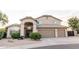 Charming home with a neutral exterior, arched entryway, and spacious three-car garage at 19276 N 90Th Pl, Scottsdale, AZ 85255