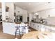 Kitchen features a breakfast bar, white cabinetry, stainless appliances, and modern fixtures at 19276 N 90Th Pl, Scottsdale, AZ 85255
