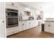 Modern kitchen featuring white cabinetry, stainless steel appliances, and granite countertops at 19276 N 90Th Pl, Scottsdale, AZ 85255