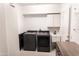 Spacious laundry area equipped with modern washer and dryer units and built-in storage cabinets at 19276 N 90Th Pl, Scottsdale, AZ 85255