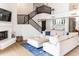 Stylish living room with fireplace, bar area, staircase, and comfortable sectional sofa at 19276 N 90Th Pl, Scottsdale, AZ 85255