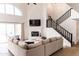 Bright living room boasts high ceilings, fireplace, a large window, and staircase at 19276 N 90Th Pl, Scottsdale, AZ 85255