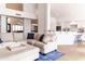 Bright living room open to kitchen, with a large sectional, and modern decor at 19276 N 90Th Pl, Scottsdale, AZ 85255