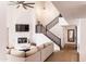 Spacious living room with fireplace, staircase, high ceilings, and modern lighting at 19276 N 90Th Pl, Scottsdale, AZ 85255