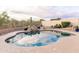 Serene backyard featuring a sparkling blue pool, decorative rock waterfall, and lush landscaping at 19276 N 90Th Pl, Scottsdale, AZ 85255