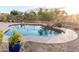 Tranquil backyard featuring a pool with a decorative rock border and manicured desert landscaping at 19276 N 90Th Pl, Scottsdale, AZ 85255