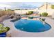 Beautiful pool with rock waterfall feature surrounded by desert landscaping at 19276 N 90Th Pl, Scottsdale, AZ 85255