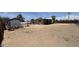 Wide shot of dirt lot backyard with miscellaneous lawn and garden equipment, as well as wood fencing at 20626 N 35Th Ave, Glendale, AZ 85308