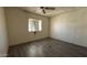 Bedroom featuring wood-look vinyl flooring, neutral wall color and a ceiling fan at 20626 N 35Th Ave, Glendale, AZ 85308