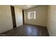 Bedroom showing flooring, neutral wall color, a window and a large closet at 20626 N 35Th Ave, Glendale, AZ 85308