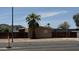 Exterior shot of home behind fence and palm tree on main street at 20626 N 35Th Ave, Glendale, AZ 85308