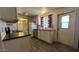 This kitchen has black appliances, a view of the dining area and white cabinetry at 20626 N 35Th Ave, Glendale, AZ 85308