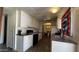 Traditional kitchen features white cabinetry, dark countertops, wood-look flooring, and stainless steel sink at 20626 N 35Th Ave, Glendale, AZ 85308