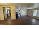 The open-concept living room has views into the kitchen with wood-look flooring and lots of natural light at 20626 N 35Th Ave, Glendale, AZ 85308