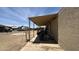 View of covered patio alongside home, with ladder, chairs, and miscellaneous outdoor equipment at 20626 N 35Th Ave, Glendale, AZ 85308