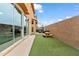 Backyard featuring a picnic table, artificial grass, and a brick wall, perfect for outdoor activities at 2237 S Jacana Ln, Gilbert, AZ 85295