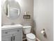 Cozy bathroom with updated vanity, neutral paint, round mirror, and decorative shelving at 2237 S Jacana Ln, Gilbert, AZ 85295
