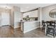 Modern kitchen with white cabinets, a breakfast bar, and updated appliances at 2237 S Jacana Ln, Gilbert, AZ 85295