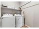 Laundry room with white appliances and a shelf for storage, optimizing space and convenience at 2237 S Jacana Ln, Gilbert, AZ 85295