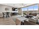 Relaxing living room with a TV, dining table, and sliding doors to the outdoor space at 2237 S Jacana Ln, Gilbert, AZ 85295