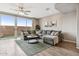 Comfortable living room featuring a large sectional sofa and sliding glass doors to the backyard at 2237 S Jacana Ln, Gilbert, AZ 85295