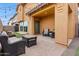 Covered patio with outdoor seating, string lights, and a paved area, ideal for entertaining at 2237 S Jacana Ln, Gilbert, AZ 85295