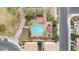 Aerial view of a community pool with lounge chairs, umbrellas and shade structures at 2237 S Jacana Ln, Gilbert, AZ 85295