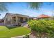 Lush backyard boasting artificial turf, mature trees, flowering plants, and inviting outdoor seating areas at 2239 N Calvin --, Mesa, AZ 85207