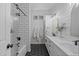Bright bathroom featuring subway tile shower, modern vanity with dual sinks and black hexagon tile floor at 2239 N Calvin --, Mesa, AZ 85207