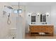 Bright bathroom featuring a double vanity, decorative mirrors, and a walk-in shower at 2239 N Calvin --, Mesa, AZ 85207