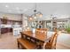 Open concept dining area, wooden table and chairs, kitchen, and living room at 2239 N Calvin --, Mesa, AZ 85207