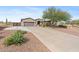 Charming home featuring a desert landscape, an attached garage, and a long driveway leading to a secure gate at 2239 N Calvin --, Mesa, AZ 85207