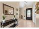 Bright foyer with tile flooring, a decorative mirror, and a modern light fixture at 2239 N Calvin --, Mesa, AZ 85207