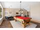 Large entertainment space with a pool table, dining area, and wood-look flooring, perfect for gatherings at 2239 N Calvin --, Mesa, AZ 85207