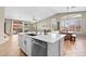 Open-concept kitchen with an island overlooking the dining area and sliding doors to the outdoor patio at 2239 N Calvin --, Mesa, AZ 85207