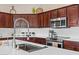 Close-up of a kitchen featuring stainless steel appliances and a white subway tile backsplash at 2239 N Calvin --, Mesa, AZ 85207
