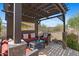 Inviting outdoor living space with a shaded pergola, comfortable seating, and stylish decor at 2239 N Calvin --, Mesa, AZ 85207