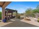 Covered patio featuring a lounge area, fire pit, and desert landscaping at 2239 N Calvin --, Mesa, AZ 85207
