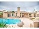 Inviting backyard featuring a sparkling pool, covered patio, and well-maintained landscaping for outdoor enjoyment at 2329 W Keating Ave, Mesa, AZ 85202