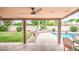 Outdoor patio with a cozy fireplace, green grass, and a refreshing pool, ideal for relaxation at 2329 W Keating Ave, Mesa, AZ 85202
