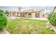 Large backyard with healthy lawn and covered patio, offering ample space for outdoor living and entertainment at 2329 W Keating Ave, Mesa, AZ 85202