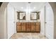 Double vanity bathroom featuring tile floors, granite countertops, and decorative framed mirrors at 2329 W Keating Ave, Mesa, AZ 85202