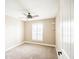 Bedroom features a ceiling fan, carpet, and a window with plantation shutters at 2329 W Keating Ave, Mesa, AZ 85202
